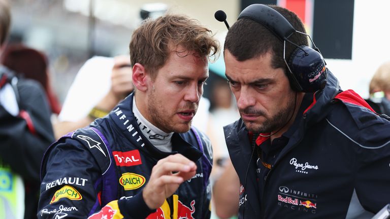 Sebastian Vettel of Red Bull talks to Guillaume Rocquelin before the Malaysian Grand Prix.