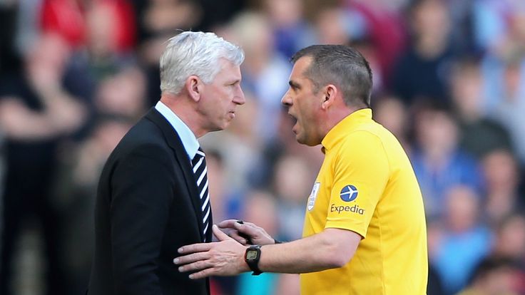 Newcastle manager Alan Pardew speaks to referee Phil Dowd during the Premier League match against West Ham United.