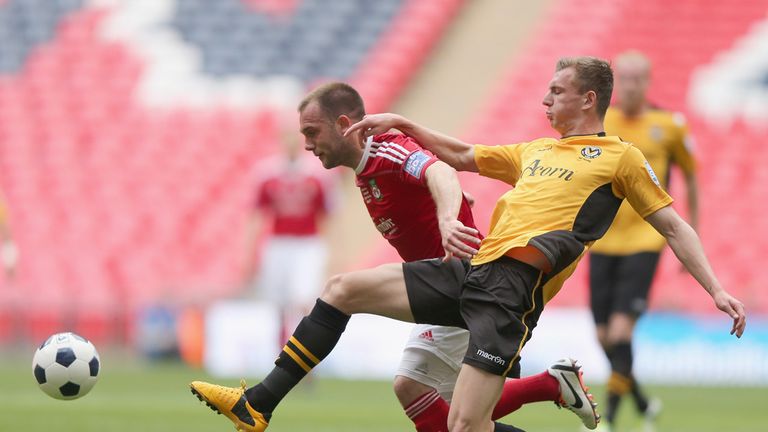 Alex Gilbey of Newport County tries to tackle Neil Ashton of Wrexham 