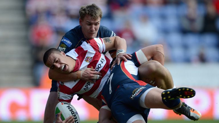 Anthony Gelling of Wigan is tackled
