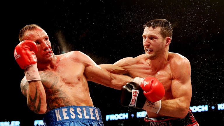 Carl Froch lands a punch during his super-middleweight unification fight against Mikkel Kessler at the O2 Arena in London