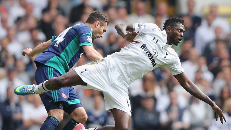 Emmanuel Adebayor is tackled by Carlos Cuellar 