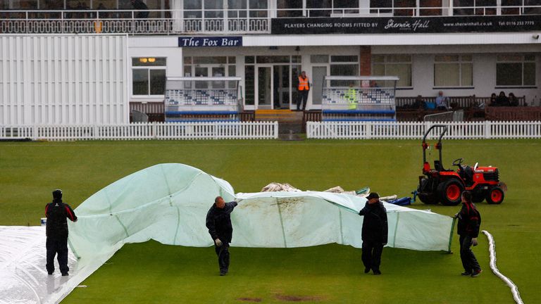 Ground staff place covers over the wicket block during day three of the tour match between England Lions and New Zealand at Grace Road
