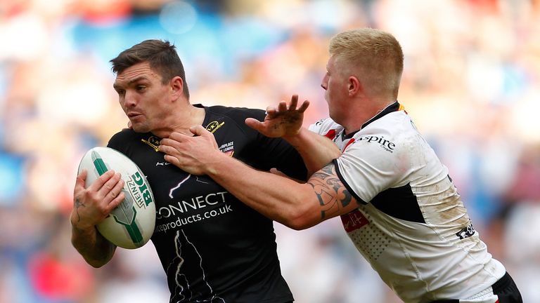 Danny Brough (L) is tackled by Danny Addy of Bradford during the Super League Magic Weekend match between Bradford Bulls and Huddersfield Giants at the Etihad Stadium