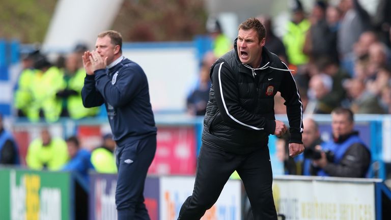 Huddersfield Town manager Mark Robins looks on as Barnsley manager David Flitcroft reacts 