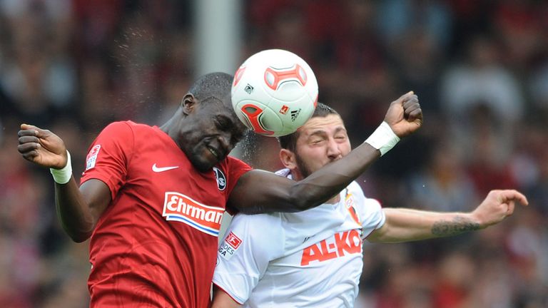 Fallou Diagne of Freiburg and Sascha Moelders of Augsburg contest a header 