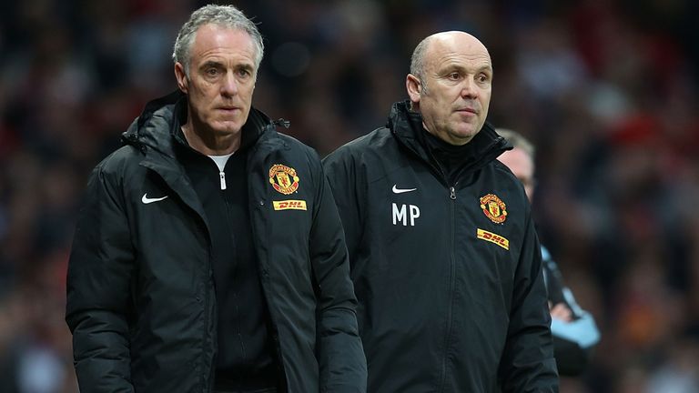 MANCHESTER, ENGLAND - APRIL 22:  Goalkeeping coach Eric Steele (L) and Assistant Manager Mike Phelan of Manchester United watch from the touchline during the Barclays Premier League match between Manchester United and Aston Villa at Old Trafford on April 22, 2013 in Manchester, England.  (Photo by Matthew Peters/Man Utd via Getty Images)