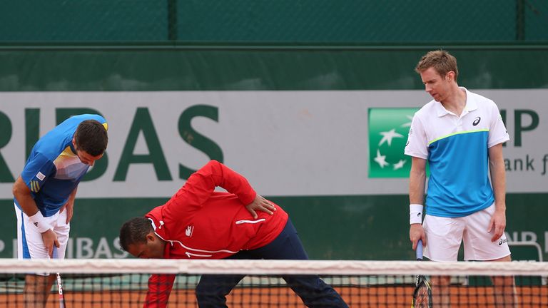 Jonathan Marray (R) and Colin Fleming of Great Britain discuss a line call 