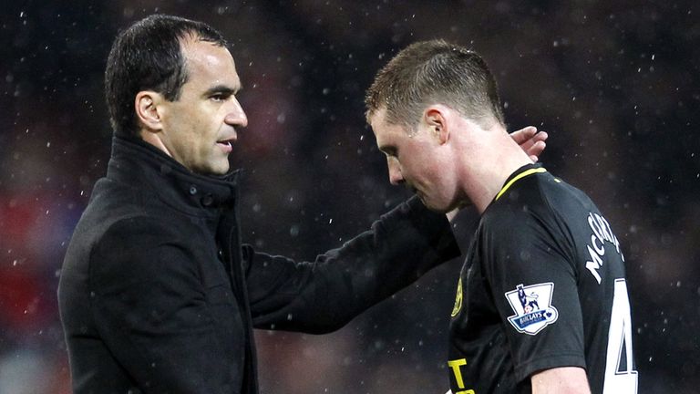 Wigan manager Roberto Martinez shakes hands with James McCarthy 