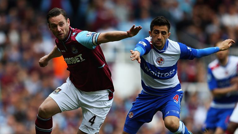 Kevin Nolan of West Ham United and Jem Karacan of Reading challenge for the ball 