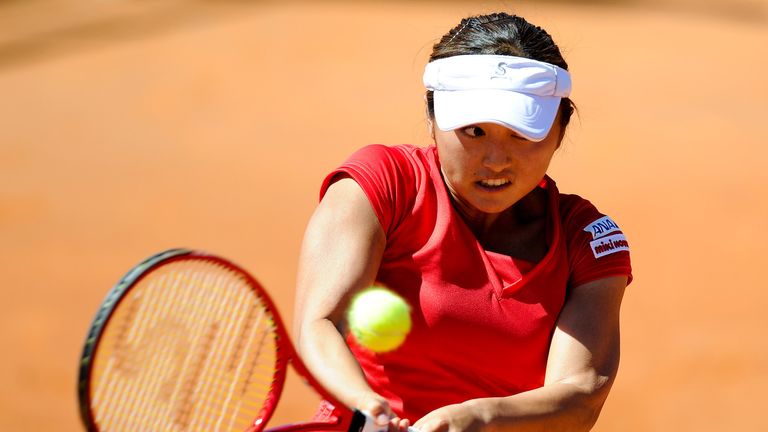 Misaki Doi of Japan returns the ball during the Fed Cup World Group Play off with Spain.