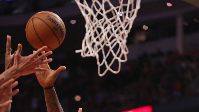 LeBron James #6 of the Miami Heat reaches for a rebound as he is grabbed by Taj Gibson #22 of the Chicago Bulls