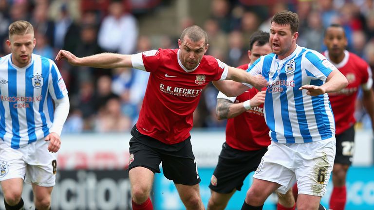 Stephen Dawson of Barnsley and Anthony Gerrard of Huddersfield Town battle for the ball 