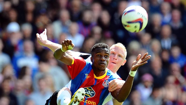 Crystal Palace's Wilfried Zaha and Peterborough United's Craig Alcock battle for the ball 