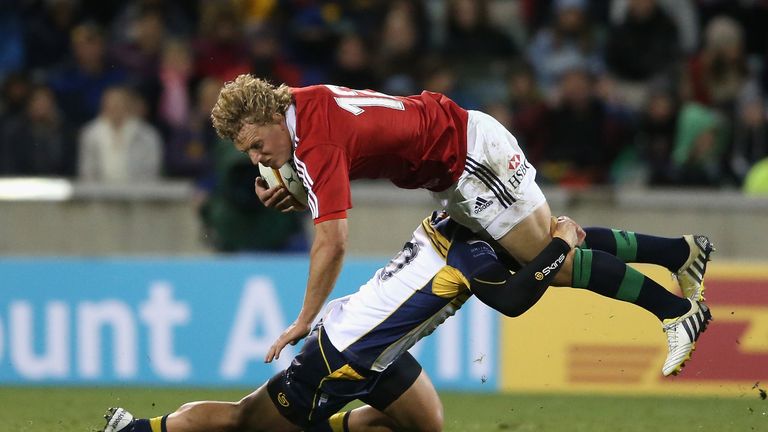 Billy Twelvetrees of the Lions is tackled by Matt Toomua during the International tour match against the Brumbies