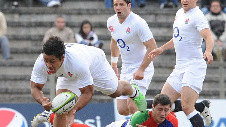 Billy Vunipola (L) of England gets past Antonio Ahualli of a South American collective team during a friendly rugby match on June 2, 2013 in Montevideo