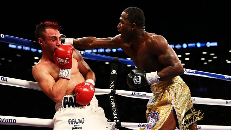 Adrien Broner (R) lands a punch on Paulie Malignaggi during their WBA welterweight title fight