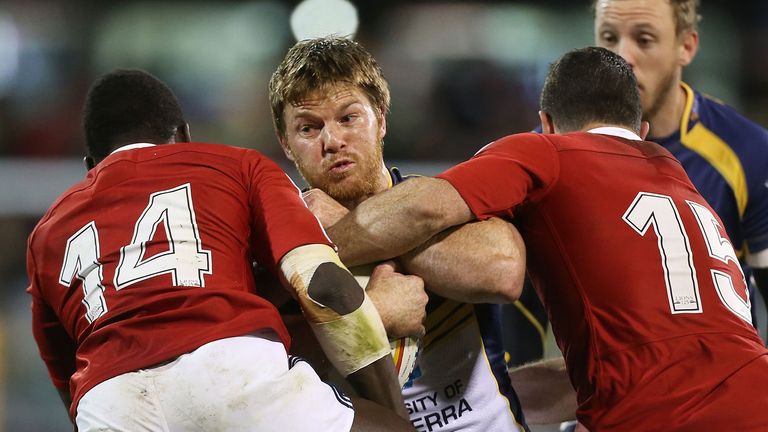 Clyde Rathbone of the Brumbies is tackled during the International tour match between against the British & Irish Lions