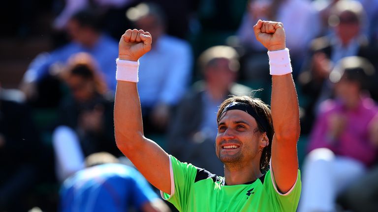 David Ferrer of Spain celebrates beating compatriot Tommy Robredo in their French Open quarter-final match at Roland Garros