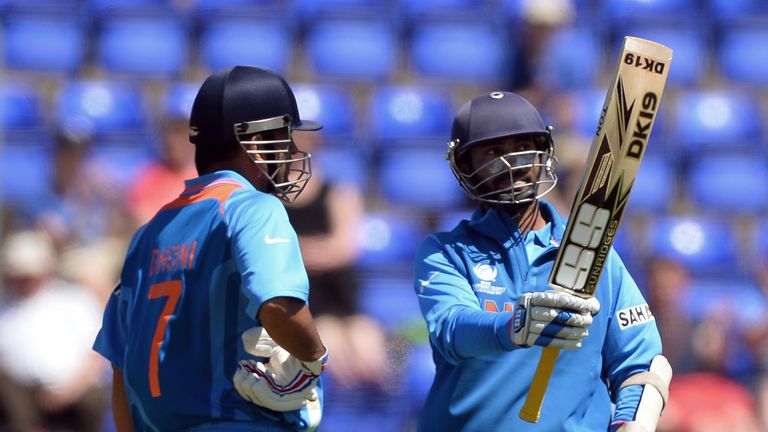 Dinesk Karthik (R) stands beside captain Mahendra Singh Dhoni during a warm-up match ahead of the ICC Champions Trophy