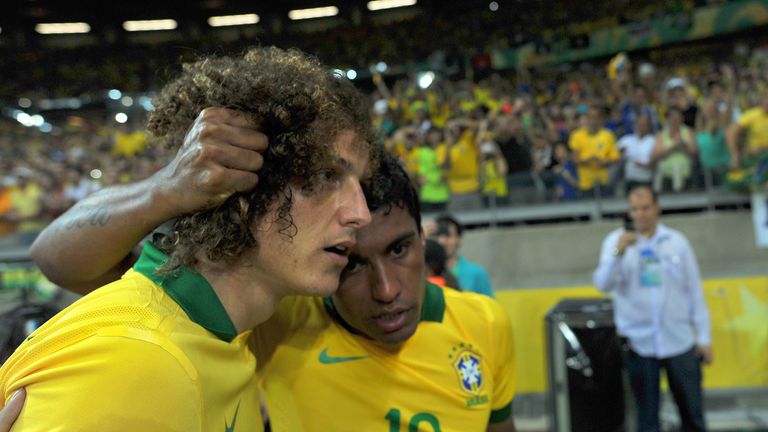 Brazil's midfielder Paulinho (r) celebrates with team-mate David Luiz after scoring against Uruguay during their FIFA Confederations Cup Brazil 2013 semi-final football match, at the Mineirao Stadium in Belo Horizonte on June 26, 2013. 