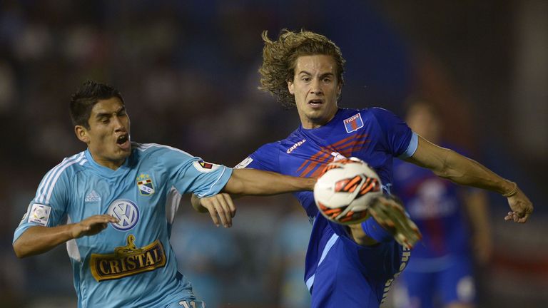 Argentina's Tigre defender Lucas Orban (R) vies for the ball with Peru's Sporting Cristal forward Irven Avila during their Copa Libertadores 2013 Group 2 football match at Tigre stadium in Victoria, Buenos Aires, Argentina on April 9, 2013. 