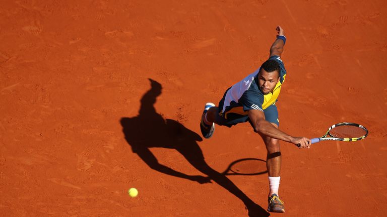 Jo-Wilfried Tsonga of France plays a backhand in his  quarter-final match against Roger Federer in the French Open