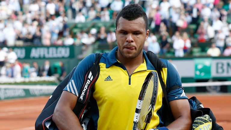 France's Jo-Wilfried Tsonga leaves the court after being defeated by Spain's David Ferrer in their French Open semi-final match