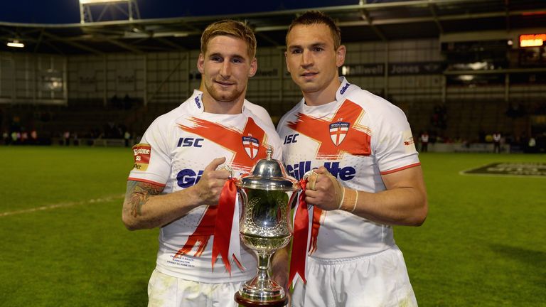 England captain Kevin Sinfield and Sam Tomkins lift the trophy after winning the International Origin Match at The Halliwell Jones Stadium