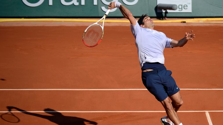 Switzerland's Roger Federer misses a shot from France's Jo-Wilfried Tsonga during their French Open quarter-final