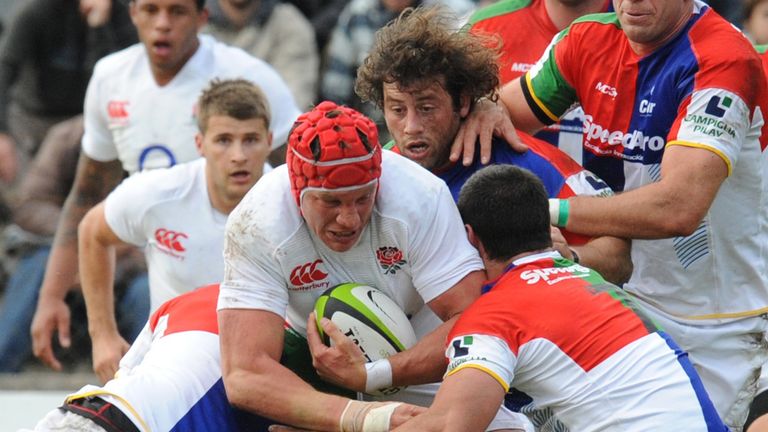Tom Johnson (C) of England vies for the ball with Javier Ortega (R) of a South American collective team during a rugby friendly match, on June 2, 2013 in Montevideo