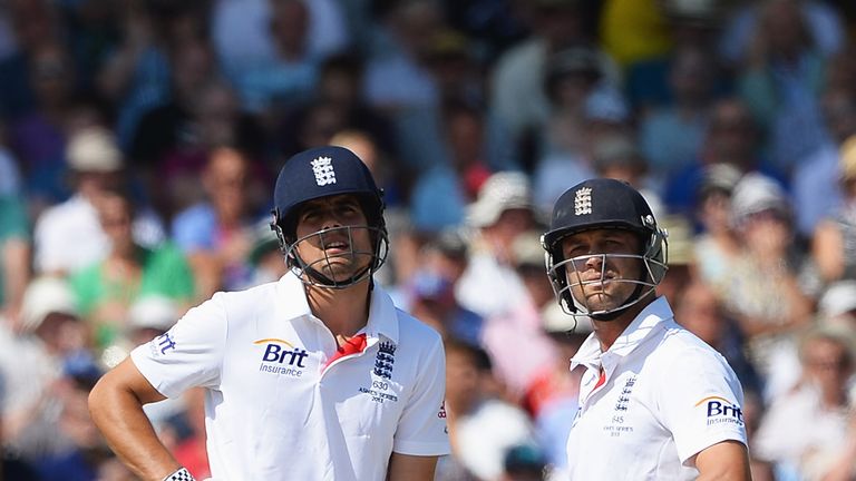 Jonathan Trott (R) waits for his referral decision with captain Alastair Cook during day two of the 1st Ashes Test
