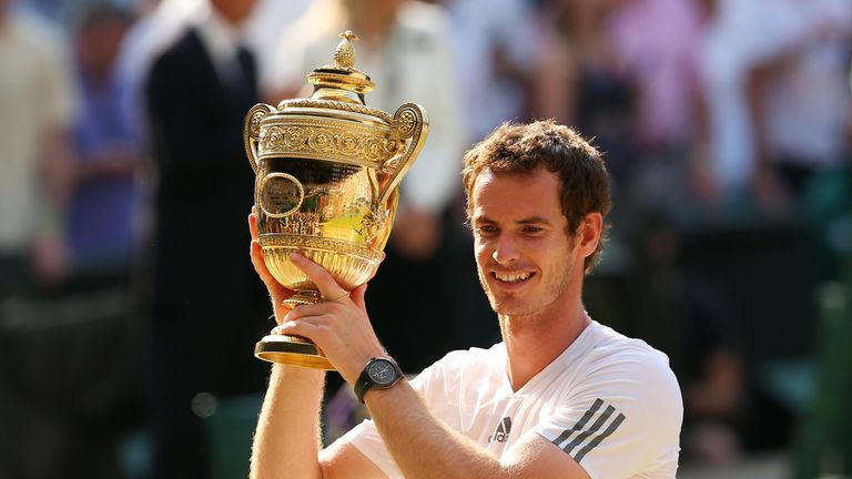 LONDON, ENGLAND - JULY 07:  Andy Murray of Great Britain poses with the Gentlemen's Singles Trophy following his victory in the Gentlemen's Singles Final match against Novak Djokovic of Serbia on day thirteen of the Wimbledon Lawn Tennis Championships at the All England Lawn Tennis and Croquet Club on July 7, 2013 in London, England.  (Photo by Julian Finney/Getty Images)