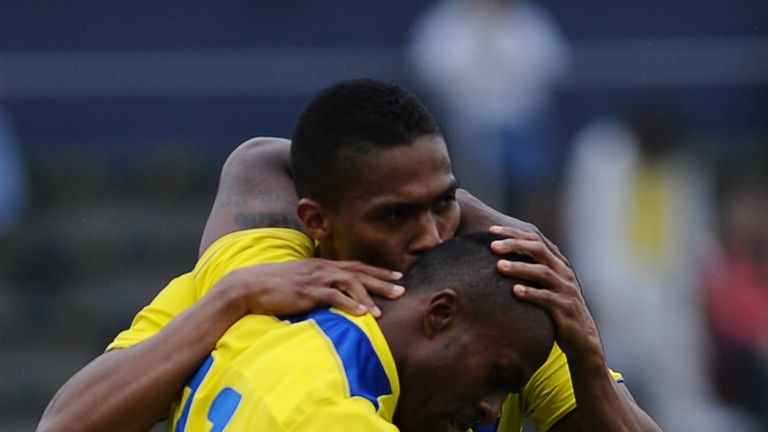 Ecuador's footballer Cristian Benitez is congratulated by teammate Antonio Valencia after scoring against El Salvador during an international friendly.
