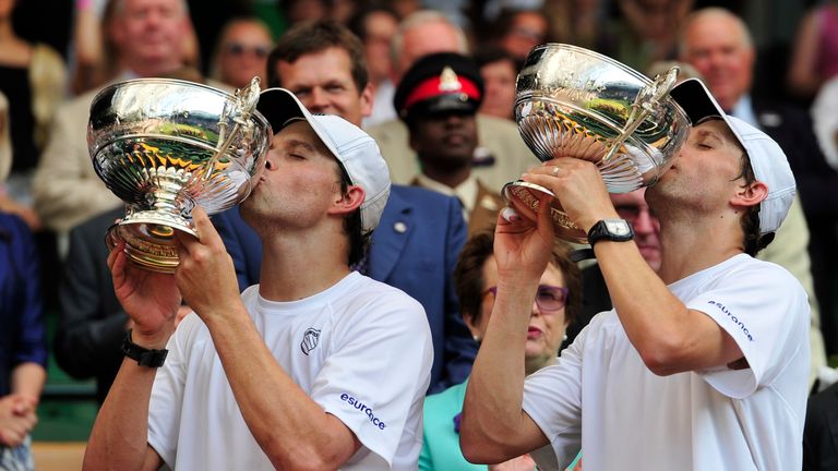 US players Bob (L) and Mike (R) Bryan kiss their winners' trophies after beating Croatia's Ivan Dodig and Brazil's Marcelo Melo in the men's doubles final match on day twelve of the 2013 Wimbledon Championships tennis tournament at the All England Club in Wimbledon, southwest London, on July 6, 2013. AFP PHOTO / GLYN KIRK  --  RESTRICTED TO EDITORIAL USE        (Photo credit should read GLYN KIRK/AFP/Getty Images)