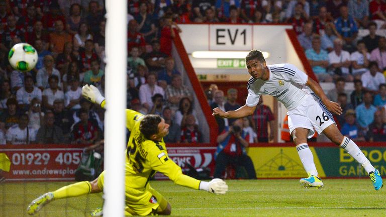 Real Madrid's Casemiro scores a goal past Bournemouth's goalkeeper Darryl Flahaven during the pre-season friendly.