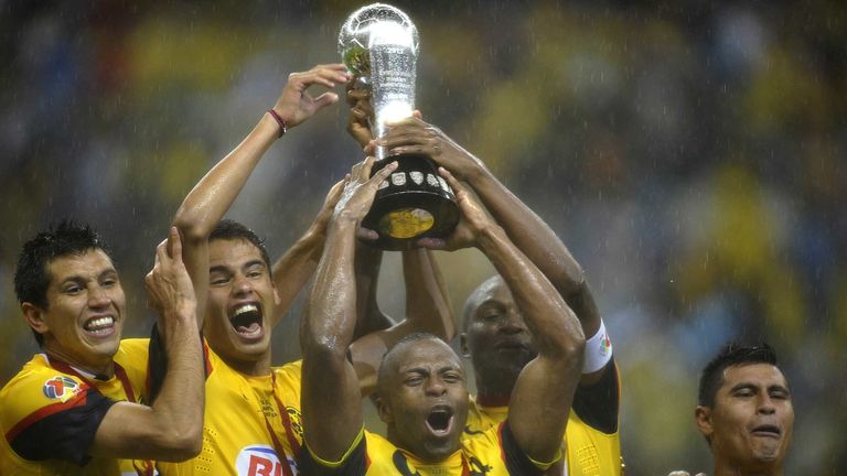 Christian Benitez of America and teammates celebrate with the Mexican Clausura tournament trophy at Azteca stadium.