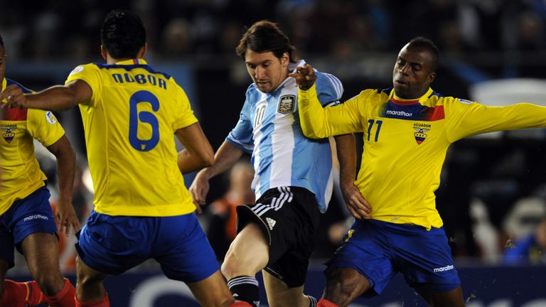 Argentina's Lionel Messi vies for the ball with Ecuador's forward Christian Benitez during their Brazil 2014 FIFA World Cup South American qualifier in Buenos Aires 2012