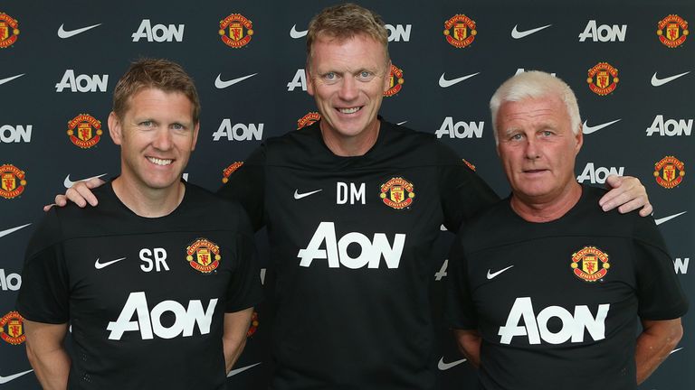 David Moyes of Manchester United (C), poses with assistant manager Steve Round (L) and coach Jimmy Lumsden (R) 