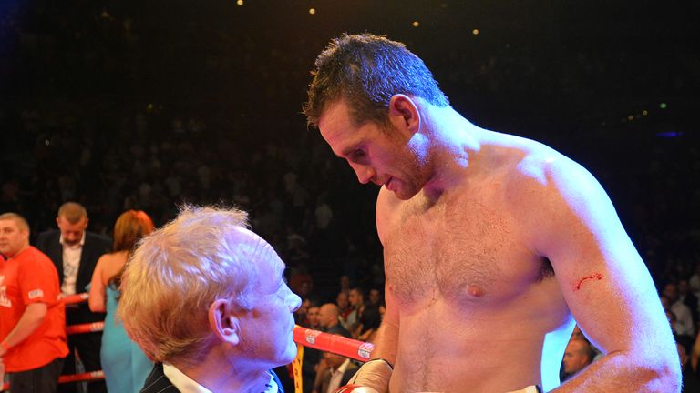 British boxer David Price (R) is consoled by promoter Frank Maloney after being beaten by US boxer Tony Thompson in their heavyweight boxing match at The Echo Arena in Liverpool