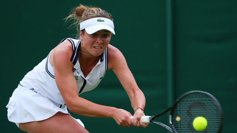 Elina Svitolina plays a backhand during her Ladies' Singles first round match against Marion Bartoli of France on day one of the Wimbledon Lawn Tennis Championships