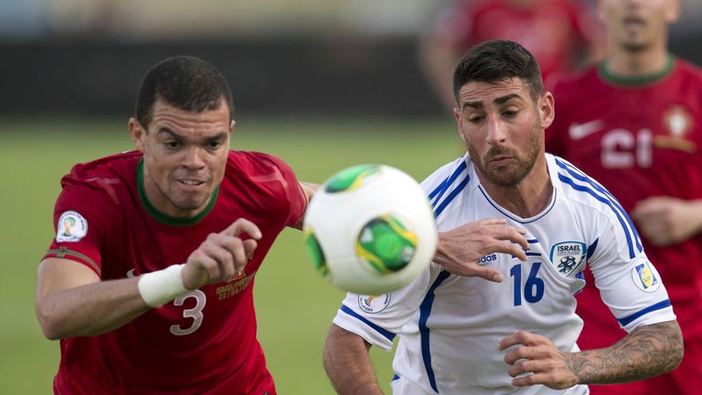 Israel?s forward Eliran Atar (R) is challenged by Portuguese defender Pepe (L) during their FIFA 2014 World Cup European zone qualifying group F match at Ramat Gan Stadium, near Tel Aviv, on March 22, 2013. AFP PHOTO / JACK GUEZ        (Photo credit should read JACK GUEZ/AFP/Getty Images)