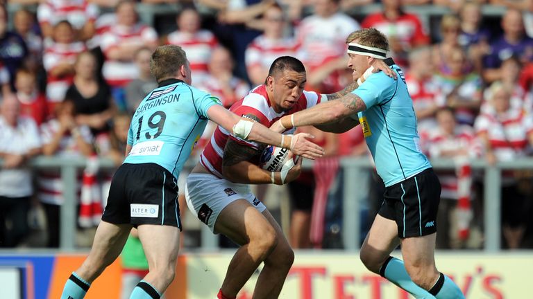 Harrison Hansen of Wigan Warriors is tackled by Dan Sarginson and Shane Rodney of London Broncos during the Tetley's Challenge Cup semi-final at Leigh