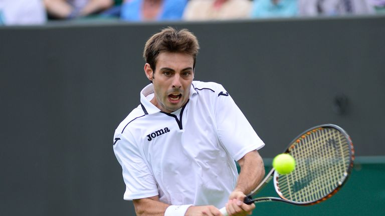 Marcel Granollers of Spain plays a backhand during his Gentlemen's Singles first round match against Richard Gasquet of France on day two of the Wimbledon Lawn Tennis Championships at the All England Lawn Tennis and Croquet Club on June 25, 2013 in London, England