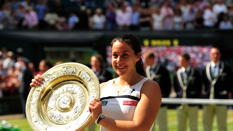 France's Marion Bartoli poses with the winner's Venus Rosewater Dish after beating Germany's Sabine Lisicki in their women's singles final match on day twelve of the 2013 Wimbledon Championships tennis tournament at the All England Club in Wimbledon, southwest London, on July 6, 2013. Bartoli won 6-1, 6-4. AFP PHOTO / GLYN KIRK  - RESTRICTED TO EDITORIAL USE        (Photo credit should read GLYN KIRK/AFP/Getty Images)