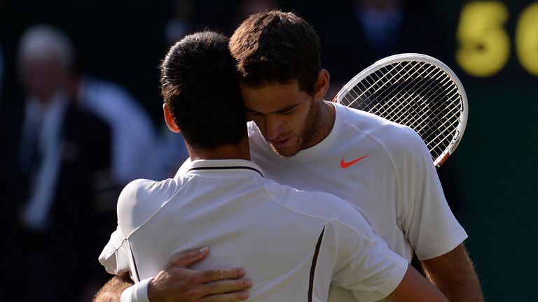 Serbia's Novak Djokovic (L) embraces Argentina's Juan Martin Del Potro (R) following Djokovic's victory in their men's singles semi-final match on day eleven of the 2013 Wimbledon Championships tennis tournament at the All England Club in Wimbledon, southwest London, on July 5, 2013.