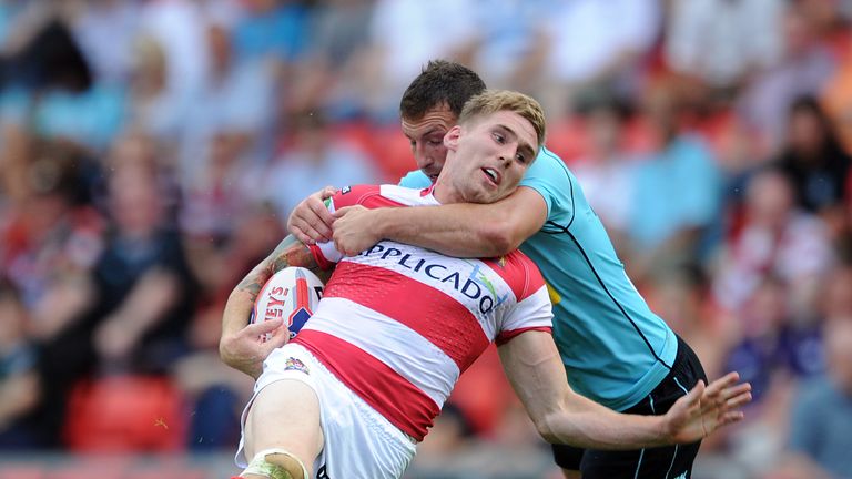 Sam Tomkins of Wigan Warriors is tackled by Tommy Lee of London Broncos during the Tetley's Challenge Cup semi-final at Leigh