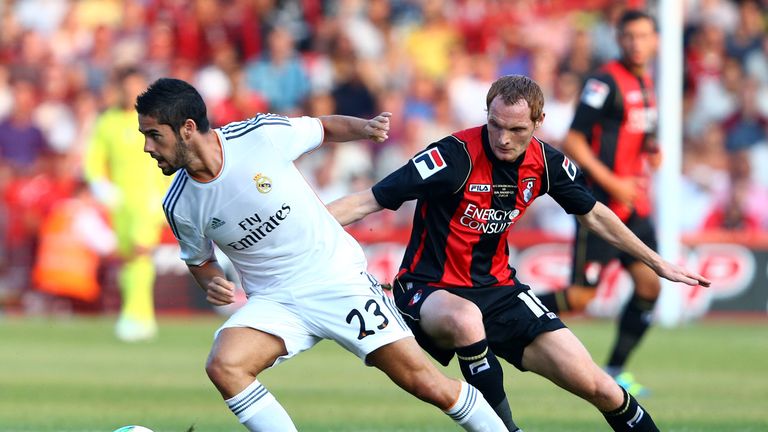 Shaun MacDonald of AFC Bournemouth battles with Isco of Real Madrid during a pre season friendly.