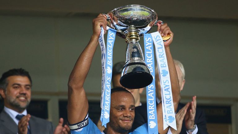 Vincent Kompany of Mancester City holds the Barclays Asia Trophy
