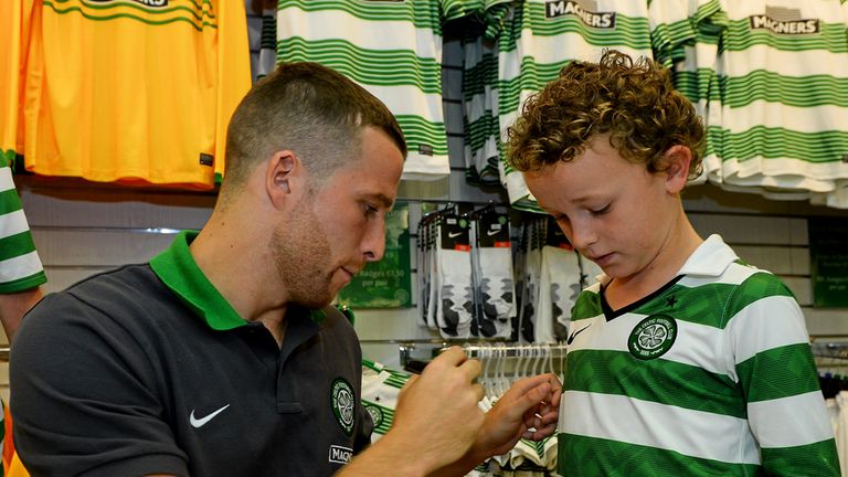 Young Celtic fan Sam White from Donegal gets his shirt signed by Adam Matthews as the defender meets supporters at the Celtic Superstore in Dublin